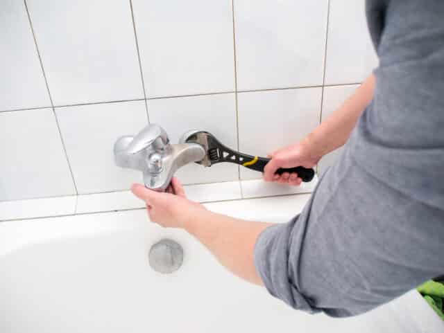 Plumber uninstalling faucet